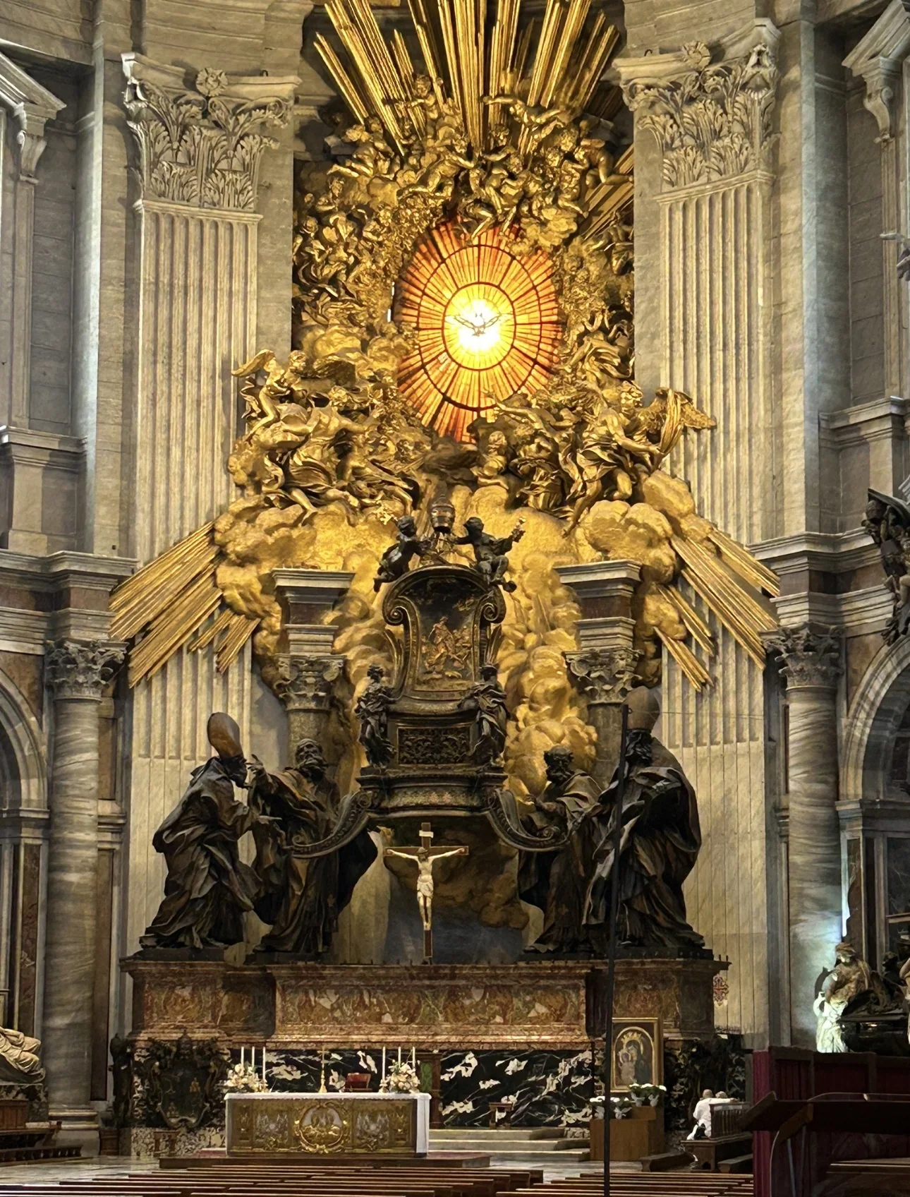 Bernini's bronze Chair of St. Peter beneath the golden window of the Holy Spirit in the apse of St. Peter's Basilica